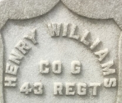 A military cemetery headstone with the name of a member of the United States Colored Troops.